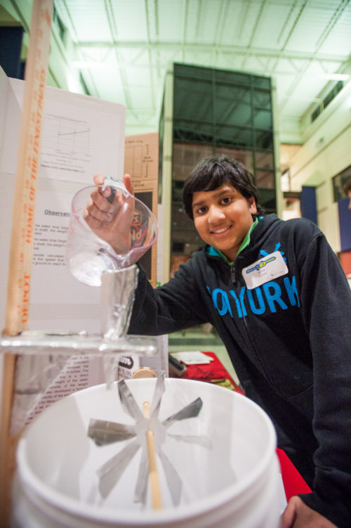 York High School student Karthik Kashyap demonstrates his science project, "The Effect of the Different Heights of Running Water on the Time Taken to Lift a Specific Object." (Photo courtesy York County School Division)