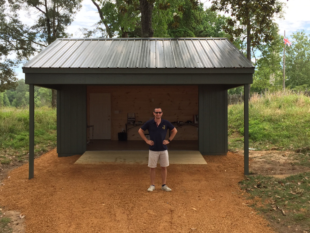 Jamestown Rediscovery Assistant Manager of Public and Educational Programs Jeff Aronowitz poses in front of the Ed Shed, a new building on Jamestown Island where guests can get a hands-on archaeology experience. (Gregory Connolly/WYDaily)