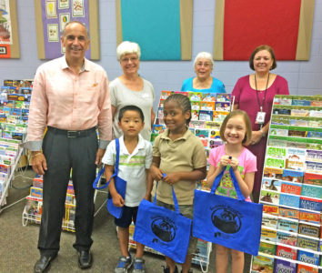 Happy readers pose with their new books at the WRL-sponsored Summer School Book Fair.
