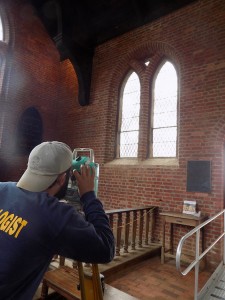 Archeologist Bob Chartrand uses a laser transit to map one of the church's windows. (Courtesy Jamestown Rediscovery)