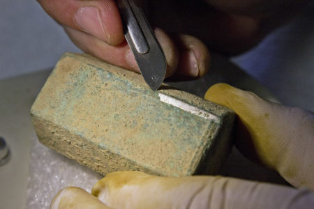 Senior Conservator Michael Lavin spent around 100 hours cleaning off and preserving the reliquary discovered at the chancel burial site. (Courtesy Jamestown Rediscovery Project)
