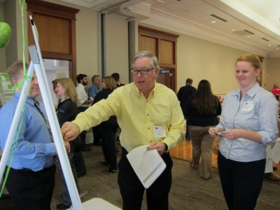James City County residents Allen Ayers and Elizabeth Miller place stickers to indicate the goals they think the county should prioritize during the strategic plan open house March 30, 2016 at Legacy Hall. (Kirsten Petersen/ WYDaily)
