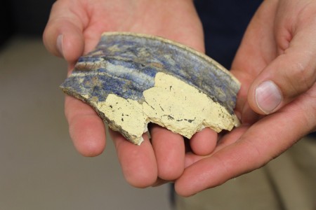 A piece of a Dutch apothecary jar discovered in the occupation layer of the well. (Elizabeth Hornsby/WYDaily)