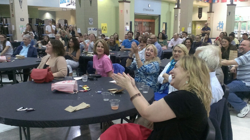 Warhill High School teacher Nicole Throckmorton (foreground) celebrates a correct answer from her appearance on "Jeopardy!" along with fellow teachers and students at the school May 3, 2016. (Kirsten Petersen/ WYDaily)