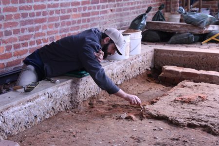 Archaeologist Bob Chartrand removes APVA backfill as he defines one of the church's many burial shafts. (Andrew Harris/WYDaily)