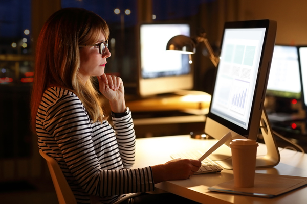 About half of American workers surveyed say they have to dip into their personal time to meet the demands of their job. (File photo)