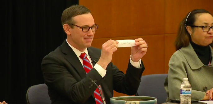 At a random drawing in Richmond on Jan. 4, 2017, State Board of Elections Chairman James B. Alcorn holds a piece of paper indicating that Del. David Yancey retained his seat in the 94th House of Delegates district. (Courtesy Facebook/WCVE)