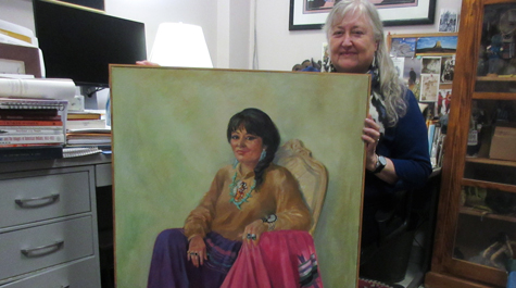 Danielle Moretti-Langholtz displays a portrait of her mentor, the late Thomasina E. Jordan, also known as Red Hawk Woman. The bill extending federal recognition to six eastern Virginia tribes bears Jordan’s name. (Joseph McClain/W&M News)