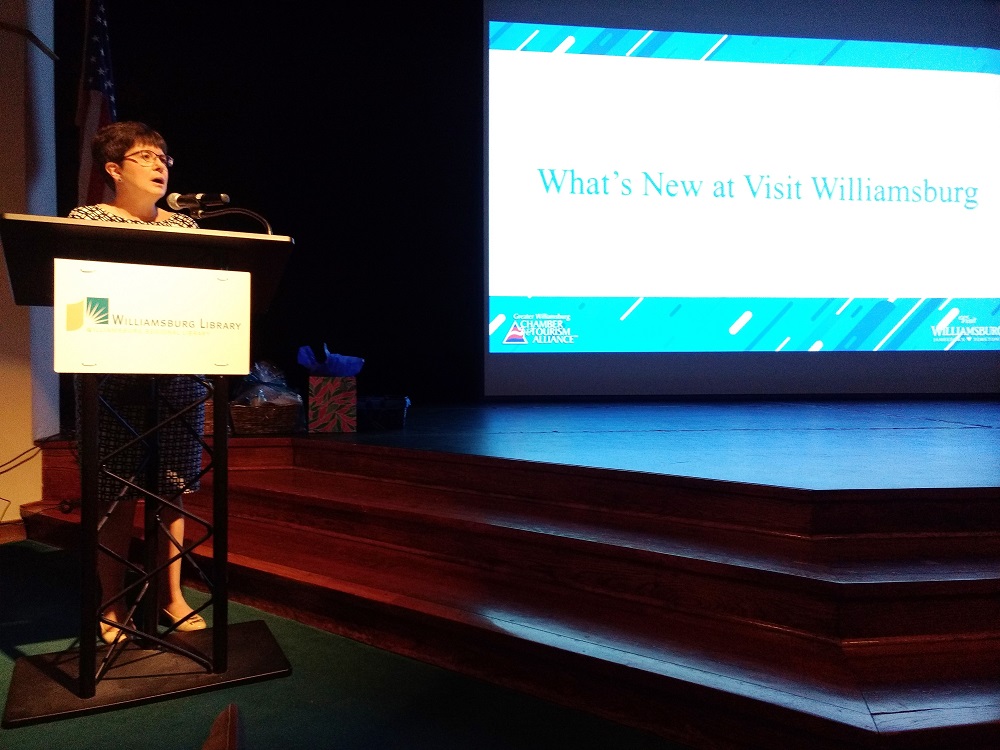 Karen Riordan of the Greater Williamsburg Chamber & Tourism Alliance discusses new attraction in the Williamsburg area at the chamber's forum on tourism. (WYDaily/Andrew Harris)