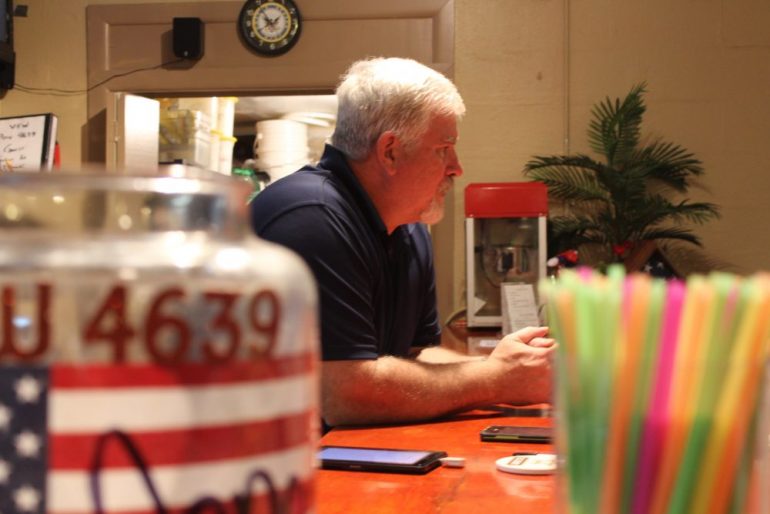 Former Post 4639 Commander Ken Shannon leans against the VFW bar as he talks to other members. The VFW is working to gain younger members. (WYDaily/Sarah Fearing)