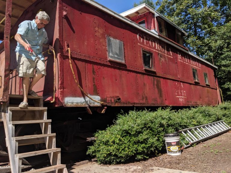William Fox exits the caboose at the Norge Depot. The caboose is still in need of work, which relies on a varying flow of money and volunteer work. (WYDaily/Sarah Fearing)