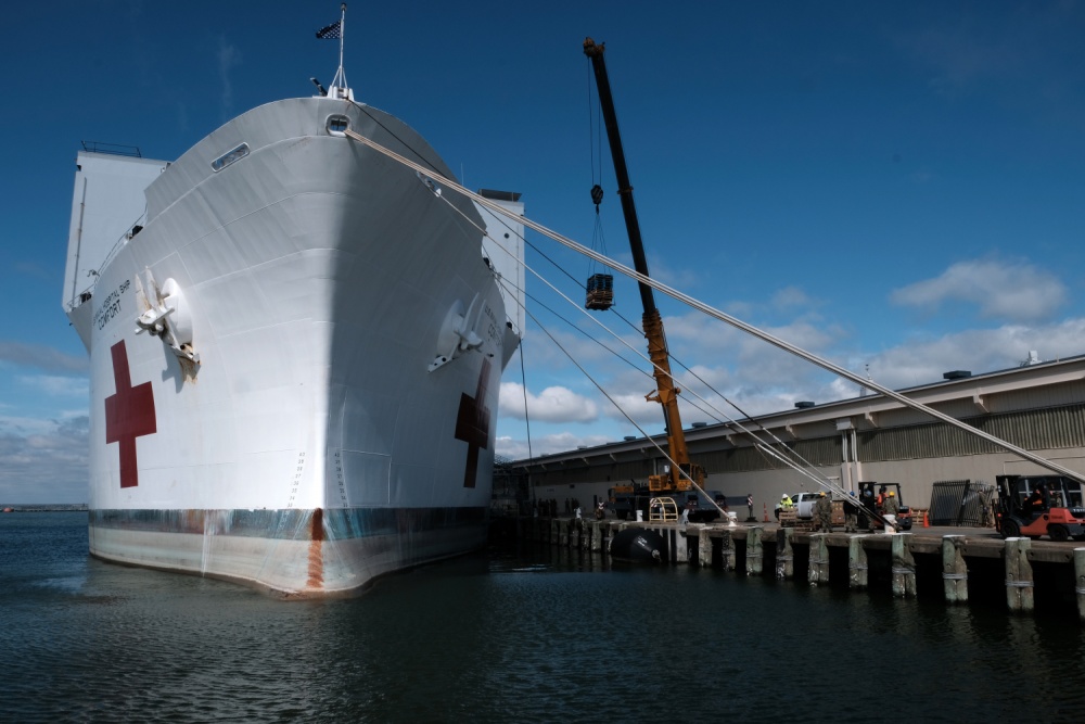 Supplies and personnel are loaded aboard the Military Sealift Command hospital ship USNS Comfort (T-AH 20) at Naval Station Norfolk, March 24, 2020. (Petty Officer 1st Class Joshua Sheppard)