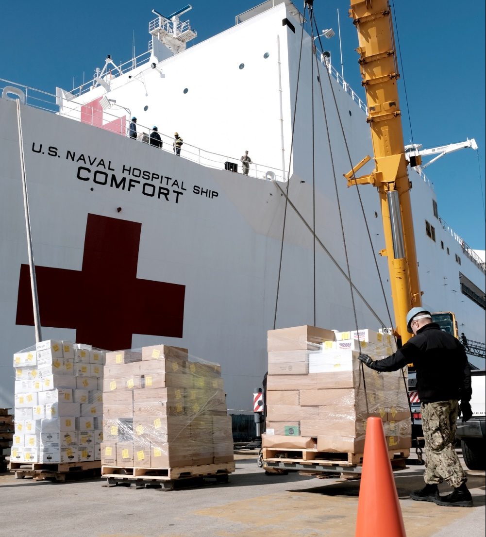 Supplies and personnel are loaded aboard the Military Sealift Command hospital ship USNS Comfort (T-AH 20) at Naval Station Norfolk, March 24, 2020. (Petty Officer 1st Class Joshua Sheppard)